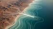 © Kasun - Aerial View of a Desert Coastline with Turquoise Water and White Foam Patterns