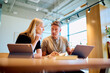 © we.bond.creations - Business colleagues collaborating on a project, discussing ideas and planning work using modern technology in a bright office