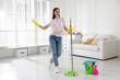 © New Africa - Spring cleaning. Happy woman having fun and tidying up floor with mop at home