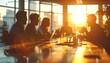© kasdi - Business team meeting at sunset office.