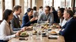 © Максим Новосветлов - Diverse group of business colleagues laughing and sharing a meal together at a bright city restaurant table.