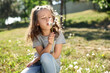 © New Africa - Cute little girl blowing dandelion in park, space for text