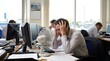© SimpleDesignStudio - Stressed middle aged Caucasian man suffering from heat in a hot office environment with a desk fan