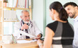 © JackF - Senior male doctor family patients examine papers, discuss medical tests result. Specialist interprets tests, tells you action plan to achieve goals of treatment. Husband and wife at pre-pregnancy