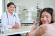 © DG PhotoStock - Asian woman accompanying elderly mother for medical checkup