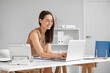 © Pixel-Shot - Young pretty secretary typing on modern laptop in light office
