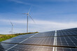 © Kittiphan - Solar panels and wind turbines generator in renewable energy farm with blue sky background for sustainable development.