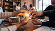 © Harry - Diverse business team collaborating on a creative project holding a glowing light bulb together
