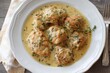 © SvoP - Tender chicken pieces simmered in a creamy herb sauce served on a white plate with fresh thyme garnish and rustic wooden background for a comforting meal