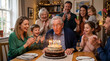 © Subodh - Happy multi-generational family celebrating grandfather's birthday at home with a two-tier chocolate cake. Elderly man blowing out candles while children and adults clap in a cozy, warm room.