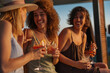 © bernardbodo - Women friends enjoying cocktails at summer sunset party