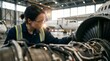 © Mr. Bolota - Female aviation mechanic inspecting an aircraft engine in a hangar