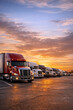 © FINS - A busy highway at sunset with multiple trucks driving away from the camera.