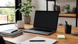 © Technolog - A laptop computer sits on a wooden desk in a modern home office with various stationery items and a plant in the background