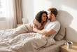 © Vieriu - Love between partners in bed. Family in the bedroom