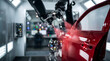 © Stocker Z I - Industrial robot arm spraying red paint on car door in automated manufacturing factory for automotive production line technology.