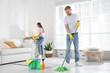 © New Africa - Spring cleaning. Man tidying up floor with mop and woman wiping dust at home