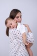 © New Africa - Happy mother and her cute little daughter on light grey background