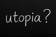 © miss irine - Utopia concept is written with chalk on blackboard. Word utopia with question mark implies search for perfect society. Future goals and ideas are considered.