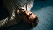 © photo for everything - Exhausted Man in Glasses Lie Down on Large Blue Print Design Document on Floor, Overwhelmed by Work and Project Planning