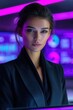 © NovaVision - Confident businesswoman in a black suit against a vibrant neon purple digital background