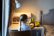 © Алина Бузунова - Young girl organizing school supplies at a desk in her bedroom