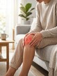 © franxxlin_studio - Woman suffering from severe knee pain sitting on sofa at home with red joint highlight