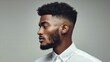 © Inrow Studio - The side profile of a black man with a perfectly styled haircut and beard, posing in a white shirt.