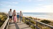 © Bane - Multi-generation family walking together on a sunny beach wooden boardwalk
