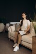 © Roman - Woman choosing upholstery fabric samples in furniture store