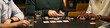 © DragonImages - Header of young adult men playing cards around table, sharing leisure time and male friendship during social gathering. Banner use for friendship, bonding, recreation marketing, wide shot