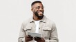 © RndVisuals - Smiling Black man wearing glasses and holding a tablet computer, looking to the side