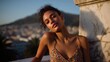 © GATE 22 - Portrait of a young woman sitting on a balcony overlooking a city. she is wearing a colorful dress with a floral pattern and gold hoop earrings.