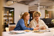 © Rido - Focused busineswomen working together on digital tablet at office