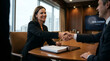 © illustratica - Professional woman closing a business deal with a handshake