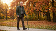 © Xenia - Confident senior man walking in autumn park with modern cane. Elderly male enjoying outdoor stroll with mobility aid. Fall season lifestyle