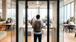 © Aurora Aesthetics - coworking space backpack professional warm routine lifestyle concept detail creative warm angle highlights everyday routine and practical visual appeal person entering modern glass office with shared
