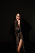 © flywish - Graceful Female Model Displays Striking Clothing Design Under Dramatic Lighting Conditions
