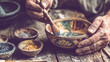 © designermetin - Potter painting ceramic bowl on rustic wooden table