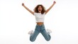 © The Little Hut - Excited young woman in casual jeans and white top jumping with joy, celebrating success against a clean white background