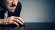 © 24DIY - Close up of a frustrated businessman with stubble intensely focused on using a computer mouse