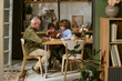 © AnnaStills - Senior Caucasian man playing chess with two kids at home, teaching strategy and bonding across generations. Useful for family lifestyle, parenting, retirement, education campaigns