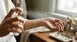 © Evelyn - Woman applying perfume on wrist indoors