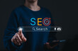 © Sandwish - SEO Search engine optimization concept. Person touching digital search bar with AI icon, mobile device, and target symbol representing online marketing strategy, keyword research, analytics and growth