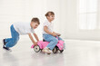 © New Africa - Little children with toy car at home, space for text