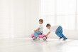 © New Africa - Little children with toy car at home, space for text
