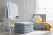 © New Africa - Folding mattress, easel, flower shaped cushion and blanket in child's room