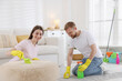 © New Africa - Spring cleaning. Couple tidying up room together at home