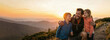 © Margarita Ratatosk - Father with daughter and son hiking in mountain at sunset. Happy parent hugging child on nature trail during Fathers Day. Family leisure, summer adventure, bonding. Banner with copy space