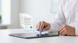 © zabhie - Businessman finger tapping tablet screen to approve electronic contract with glowing digital signature paper documents and green checkmark icon for legal verification concept